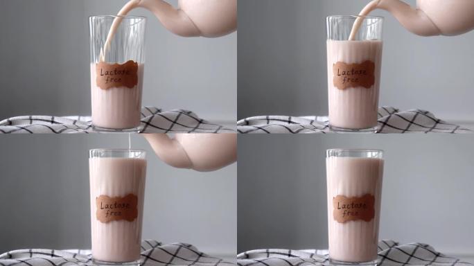 茶壶将不含乳糖的牛奶倒入stan中。餐巾纸上标记无乳糖的植物性牛奶