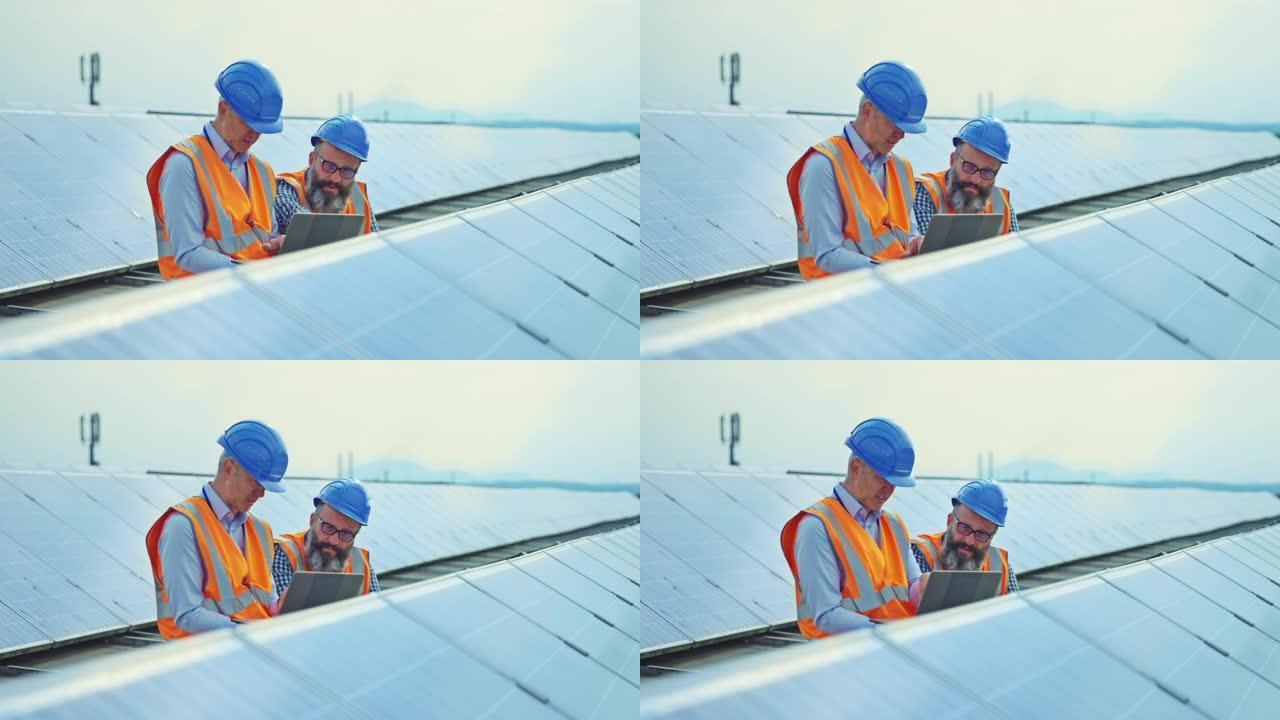 两名男性工程师在屋顶太阳能发电厂工作，并用数字平板电脑检查光伏电池板的操作