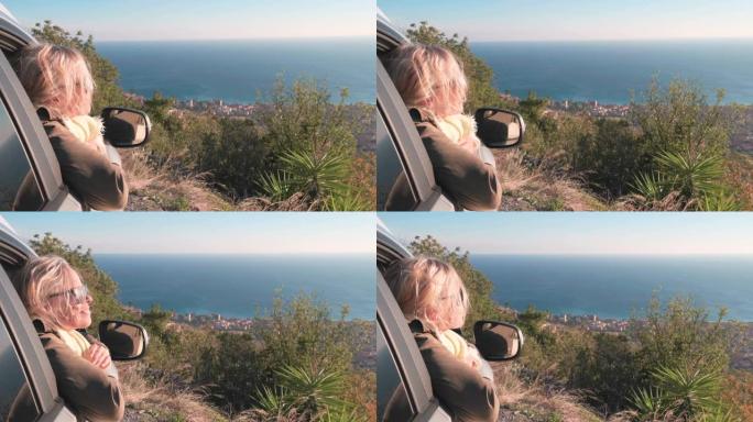 成熟的女人从汽车乘客座位上欣赏风景