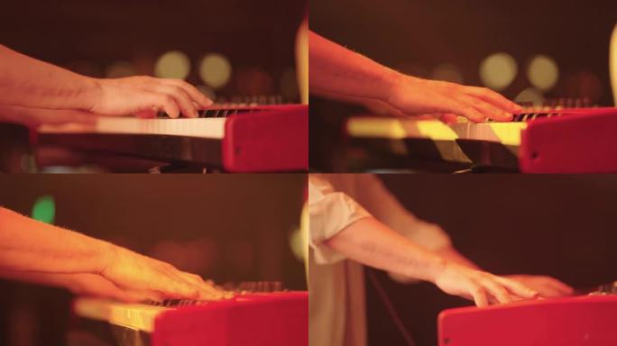 音乐家在键盘上演奏，在舞台上摇滚演出时特写镜头，迪斯科，嘻哈或放克音乐