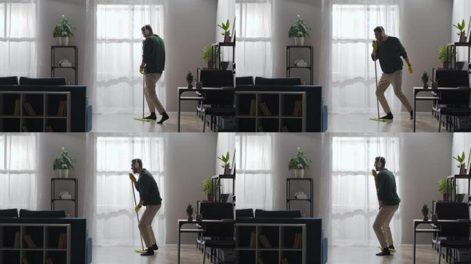 有趣的人在家里打扫卫生时唱着拖把，戴着耳机听音乐，跳舞