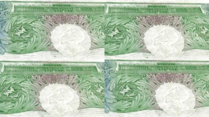 英国英镑纸币-1英镑纸币带皇冠全息图的细节-英国1英镑纸币-新聚合物1英镑的内部特写镜头 & 旧1英