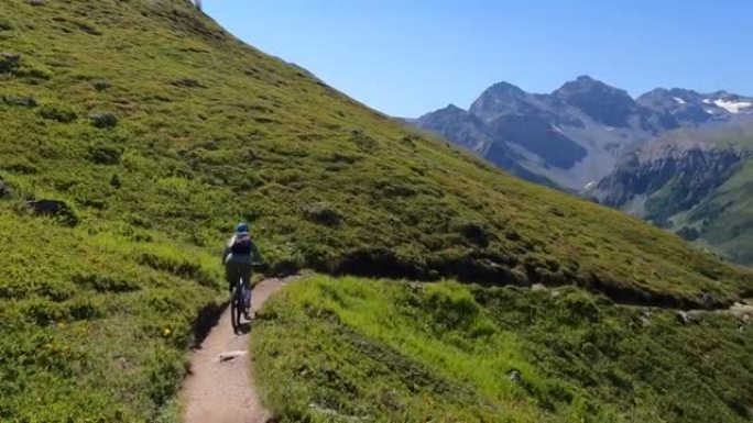 女子山地自行车沿高山路径的第一人称视角