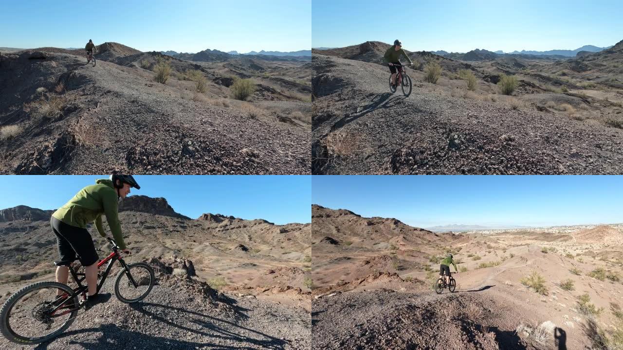 男性山地自行车手沿着崎岖的地形沙漠路径
