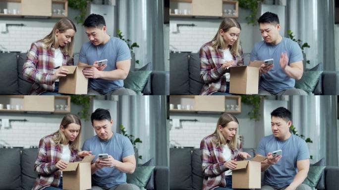 震惊沮丧的夫妇顾客打开纸箱收到错误或损坏的购物订单包裹。悲伤的年轻亚洲男女拆包错误的包裹