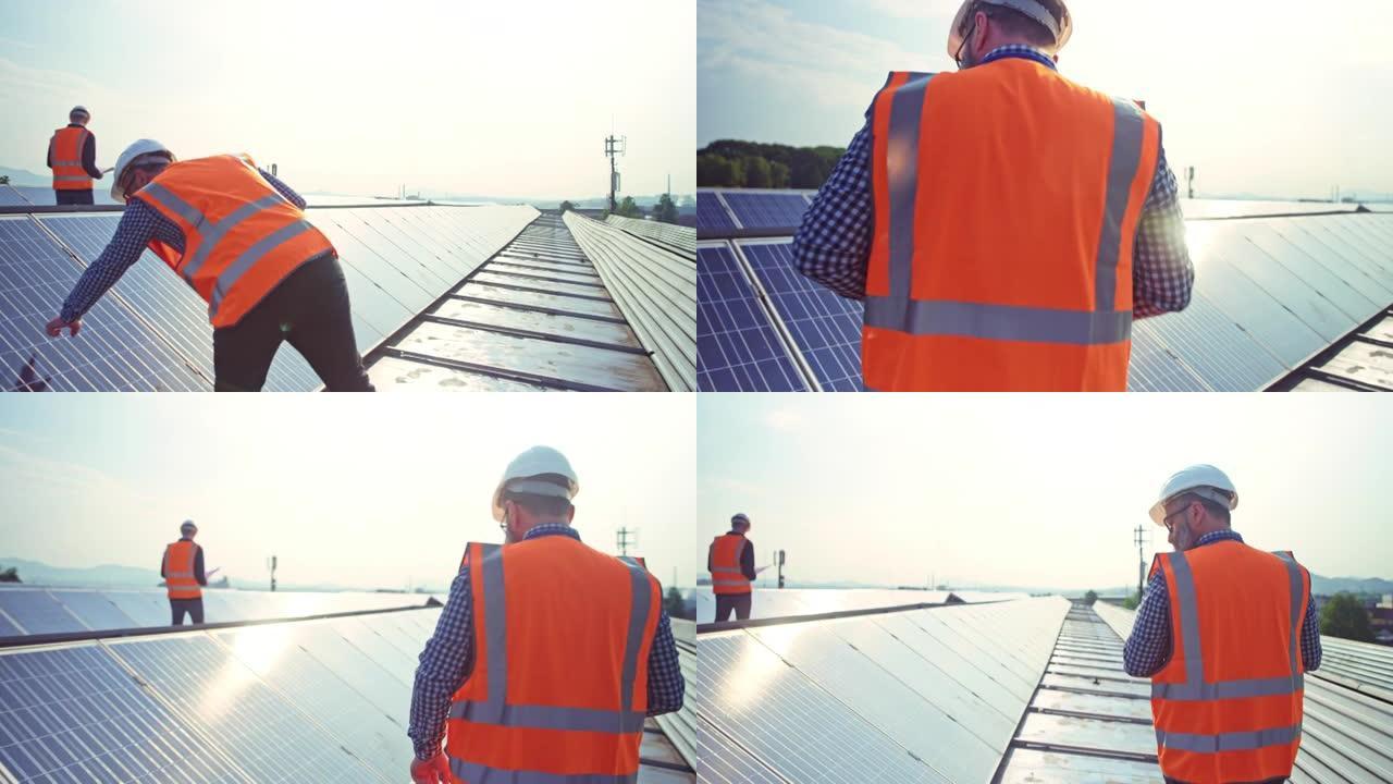 TS男工程师检查太阳能电池板在屋顶发电厂上穿过一排