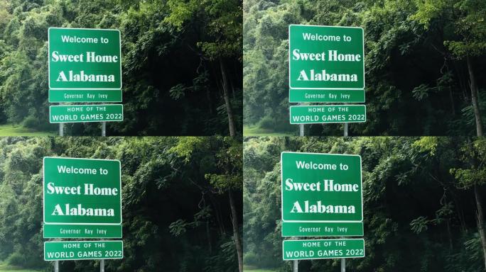 树木构成了 “欢迎来到阿拉巴马州甜蜜之家” 州田纳西州/阿拉巴马州边界标志