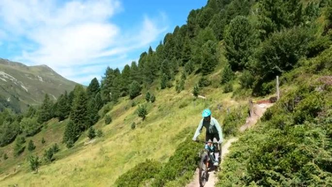 沿着高山小路骑山地自行车的女人