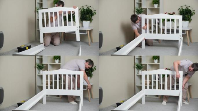 一名男子组装了一张儿童木床的床身