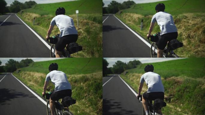 慢动作镜头跟随骑自行车的人上路，衬衫在风中吹动