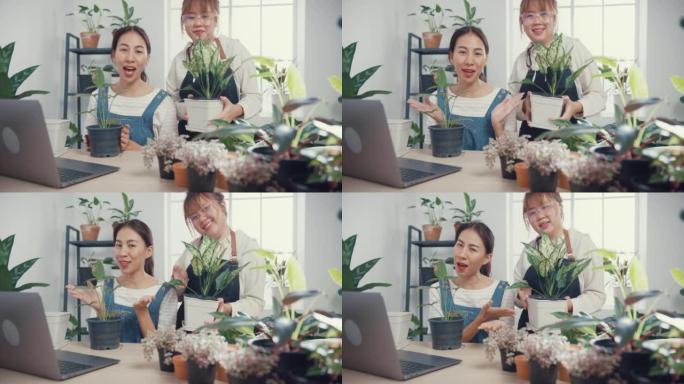 年轻的亚洲女性使用笔记本电脑接收采购订单，并在早上在树木商店通过相机在线展示植物录制视频。