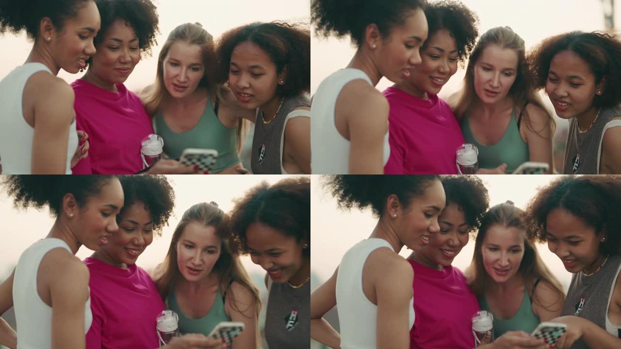 多种族女性群体在一起使用智能手机时放松和享受对话