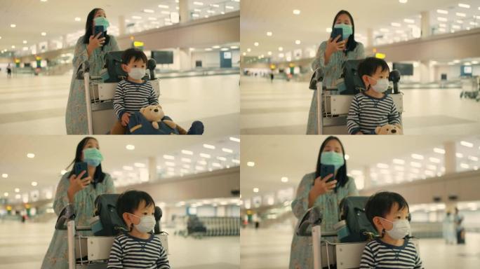 一个女人和儿子推着行李车来到机场的登机门。