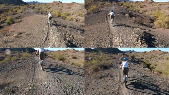 沿着沙漠小径的女子山地自行车