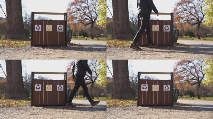 一个男人在公园的垃圾箱里扔废物的细节镜头