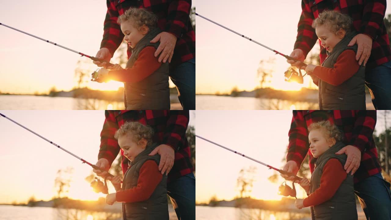 快乐的小男孩在钓鱼和大笑，夏天在大自然中与父亲或祖父休息