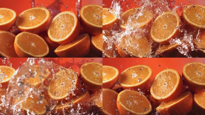 通过橙色切片溅水的慢动作镜头