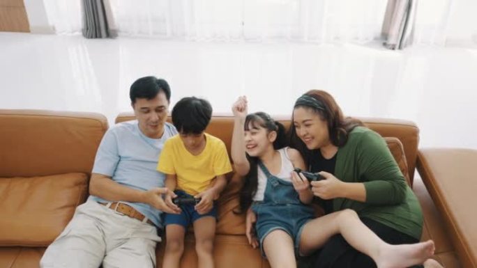一家人一起玩电子游戏时玩得很开心。