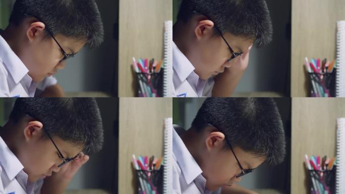 亚洲男生校服戴眼镜阅读书籍近视症状