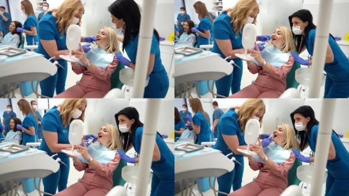 女牙医与女病人为牙齿美白选择正确的牙齿颜色
