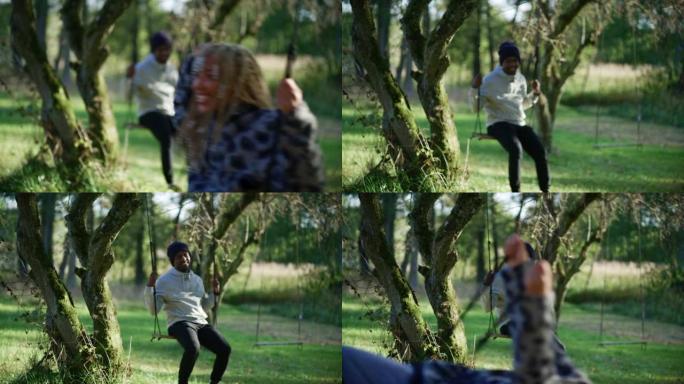 非洲族裔青少年异性恋夫妇在秋季公园的秋千上来回摇摆