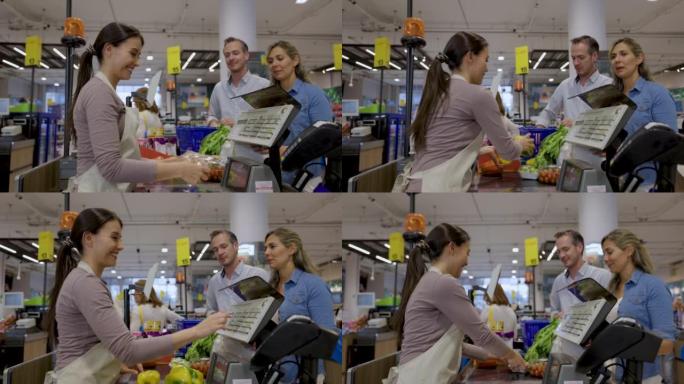 Friendly cashier scanning the products of adult he