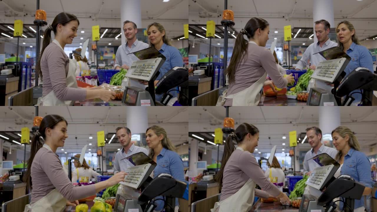 Friendly cashier scanning the products of adult he