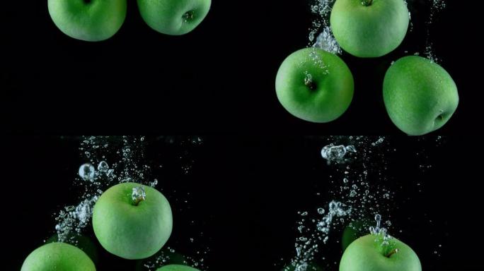SLO MO LD绿色苹果掉入水中并产生气泡