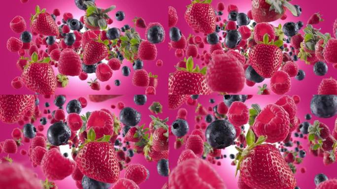 粉色紫红色背景下的草莓覆盆子蓝莓爆发