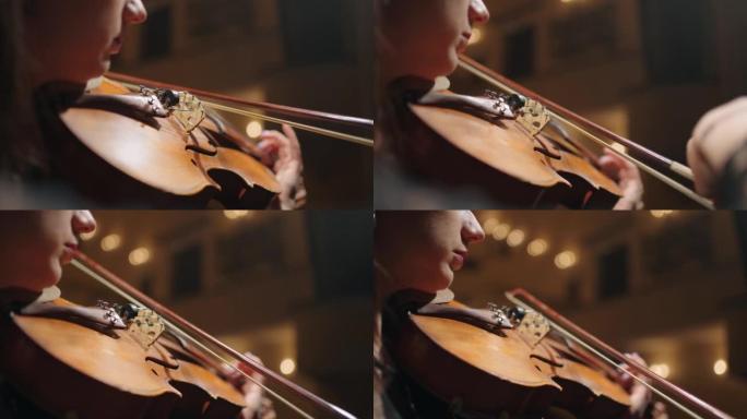 受启发的女人正在拉小提琴，女性手中的老小提琴的特写镜头