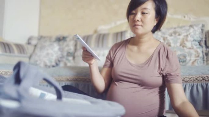 孕妇将未出生的婴儿的摇篮放在一起