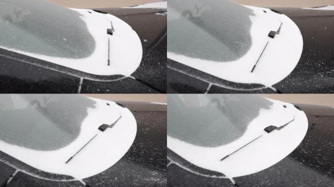 爱沙尼亚黑车挡风玻璃上的白雪