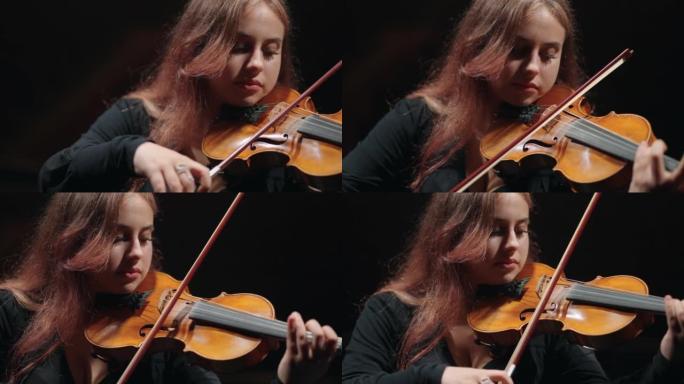 年轻的女提琴手正在爱乐音乐厅学习拉小提琴或中提琴