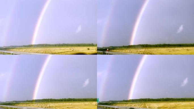 POV汽车驾驶。在雨中追逐彩虹