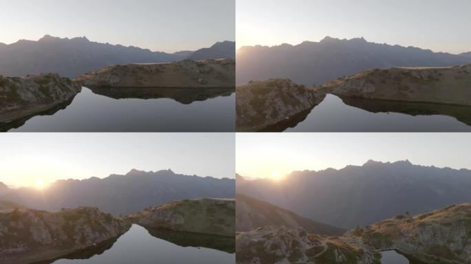 日落时高山湖的空中无人机视图