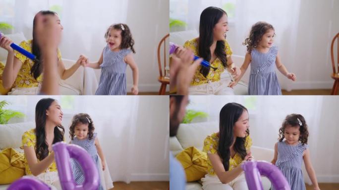 幸福快乐的家庭时刻爸爸妈妈和女儿一起玩耍坐在地板上，准备打开东西回家在新家的客厅搬家，女儿带着气球向