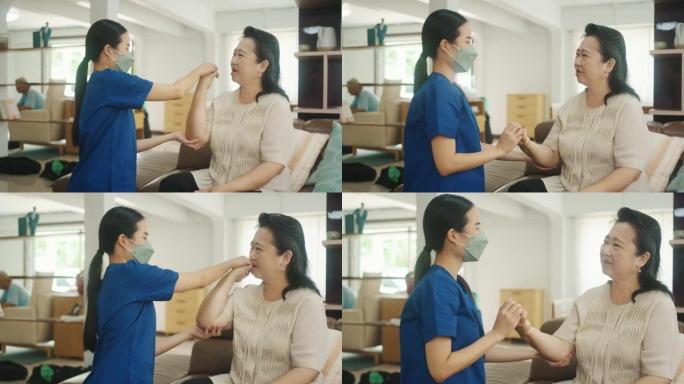亚洲高级女性在家在治疗师医生的支持下做理疗师
