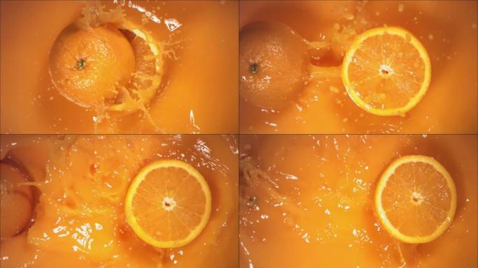 橙色水果随着飞溅落在果汁上，分成两半。