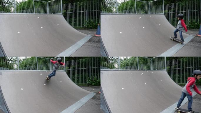 一个小男孩在滑板公园里玩滑板把戏的慢动作镜头