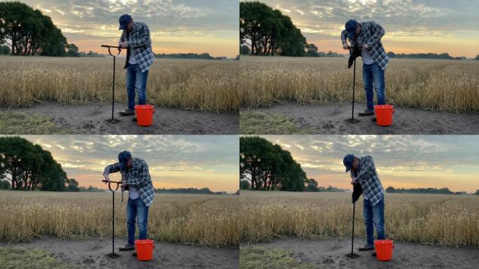 农学家用土壤探针取样，在拂晓的谷物田