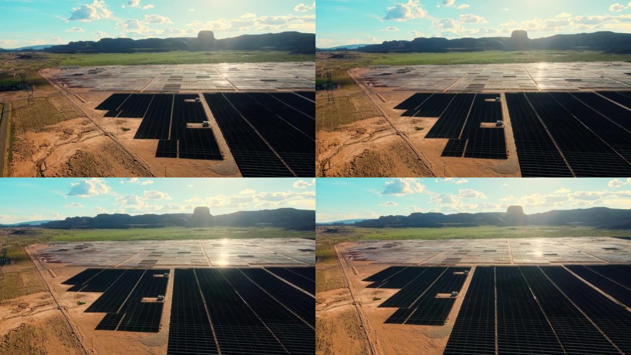 无人机在纪念碑谷附近的亚利桑那州巨大的太阳能农场的空中飞行远景。通过太阳能电池板生产绿色能源