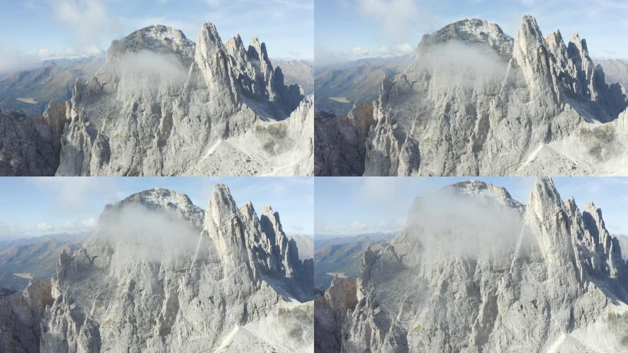 在高耸的山峰和山谷之间飞行的鸟瞰图