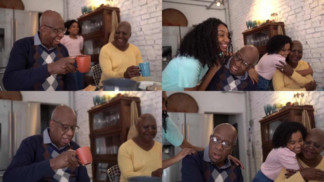 小女孩在家里吃早餐时拥抱爷爷奶奶