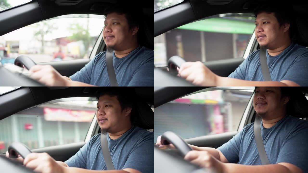 快乐的男人在开车时微笑着在车里听音乐