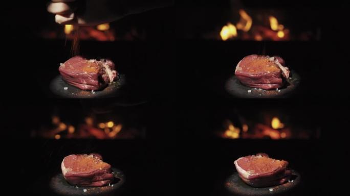 一块牛肉在火的背景下旋转。撒上辣椒粉