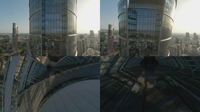 映照蓝天的玻璃摩天大楼。FPV无人机转弯并向上移动建筑物