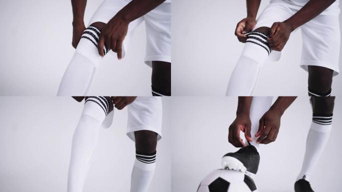 非洲足球运动员正在拉膝盖袜子，特写镜头，穿着专业运动制服