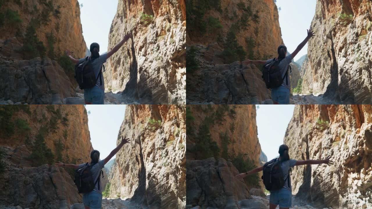 欣赏和拥抱岩石悬崖的女人