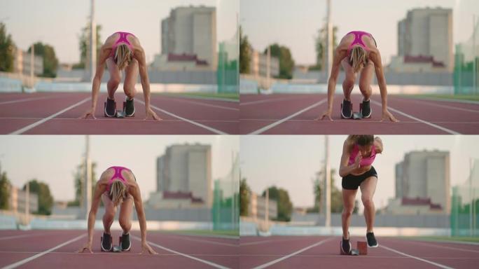 在体育场竞技场的阳光下，一名年轻的女子跑步者为跑步做准备，穿上跑鞋，以慢动作从起跑线冲刺。