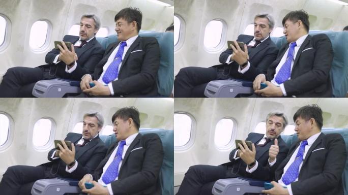 多民族商人在飞行中使用手机